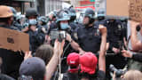 Protesters kneel in front of police during a demonstration on Broadway near New York City's Union Square, June 2, 2020.