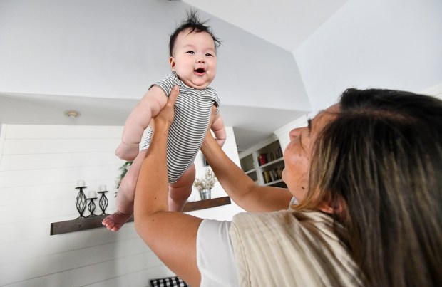 Allyson Way plays with her grandson, Owen Shin, 3-months, at their one-story home in Altadena. The Way's are in the process of converting a detached three-car garage into a living unit for their daughter, son-in-law and three-month-old grandson. (Photo by Keith Durflinger, Contributing Photographer)