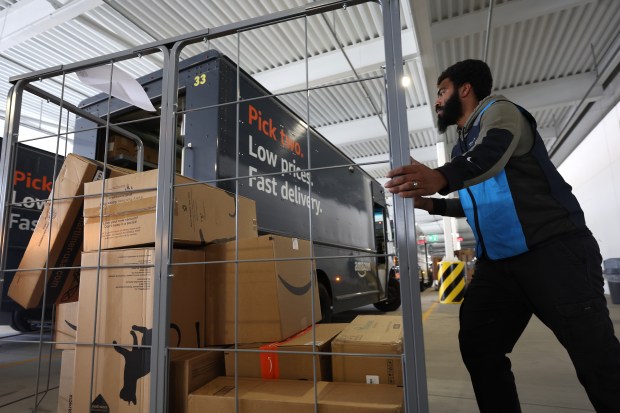 ALPHARETTA, GEORGIA - NOVEMBER 28: An Amazon driver loads packages into a delivery van at an Amazon delivery station on November 28, 2022 in Alpharetta, Georgia. Amazon is offering deep discounts on popular products ffor Cyber Monday, its busiest shopping day of the year. (Photo by Justin Sullivan/Getty Images)