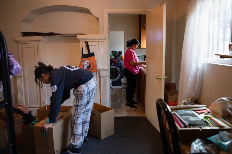 Fabiola Correa and Maria Vela pack up their belongings at their home in East Los Angeles on Dec. 17, 2020. Photo by Adriana Heldiz, CalMatters