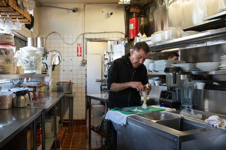 Sergio Carrillo prepares food at El Ricon restaurant in the San Ysidro neighborhood of San Diego on April 16, 2024. The restaurant is one of several business that has been affected by the recent closures of the U.S.-Mexico border. Photo by Adriana Heldiz, CalMatters